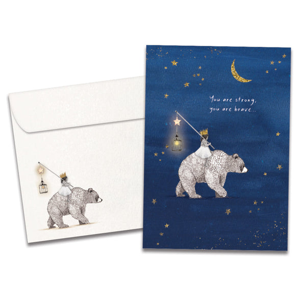 Cover of Brave Strong Bear Support & Encouragement card (featuring serif text above artwork of a girl sitting on a bear's back surrounded by stars) and its matching envelope