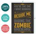 Load image into Gallery viewer, The cover of Tree-Free’s Zombie Apocalypse card with lines demonstrating its 5x7 dimensions, along with the following text: “100% PCW recycled paper, proudly made in the USA, sustainably printed on extra-thick card stock”
