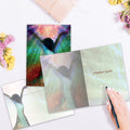 Load image into Gallery viewer, The inside of Tree-Free’s Miracles Happen card, with the cover and envelope in the background.
