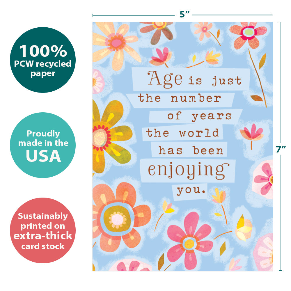 The cover of Tree-Free’s The World Enjoys You card with lines demonstrating its 5x7 dimensions, along with the following text: “100% PCW recycled paper, proudly made in the USA, sustainably printed on extra-thick card stock”