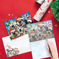 Load image into Gallery viewer, The inside of Tree-Free’s Holiday Dog Selfie Christmas Card card, with the cover and envelope in the background.
