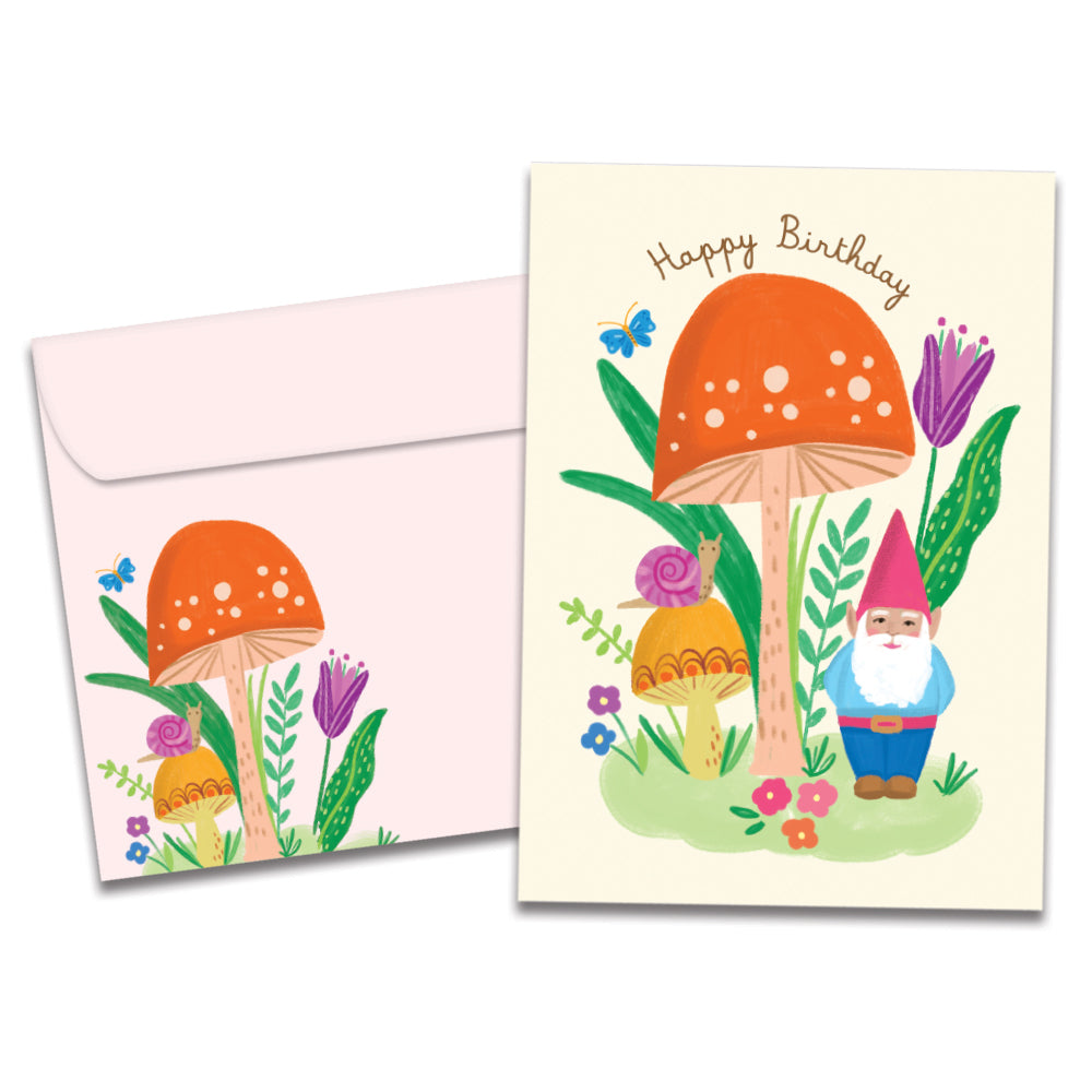 Cover of Grow Your Own Magic Birthday card (featuring script text above artwork of a gnome and a snail standing under a mushroom surrounded by flowers) and its matching envelope