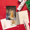 Load image into Gallery viewer, The inside of Tree-Free’s Calm and Bright card, with the cover and envelope in the background.
