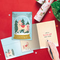 Load image into Gallery viewer, The inside of Tree-Free’s Christmas Unicorn card, with the cover and envelope in the background.
